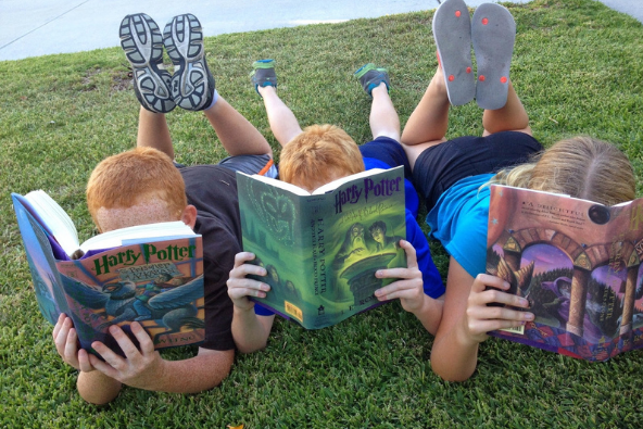 group of kids reading harry potter